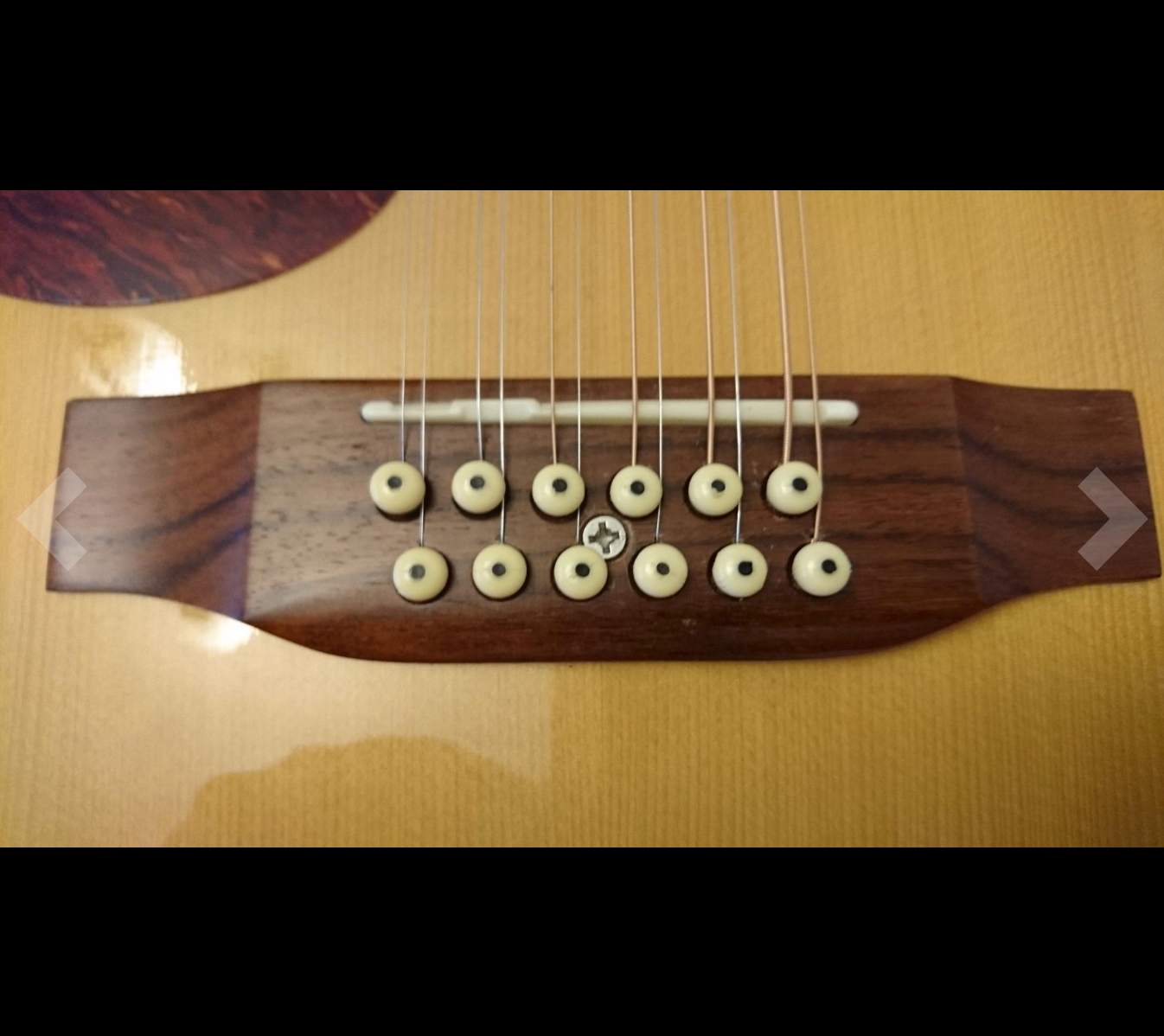 Locating the Screw between two rows of Bridge Pins (Don't do this!)